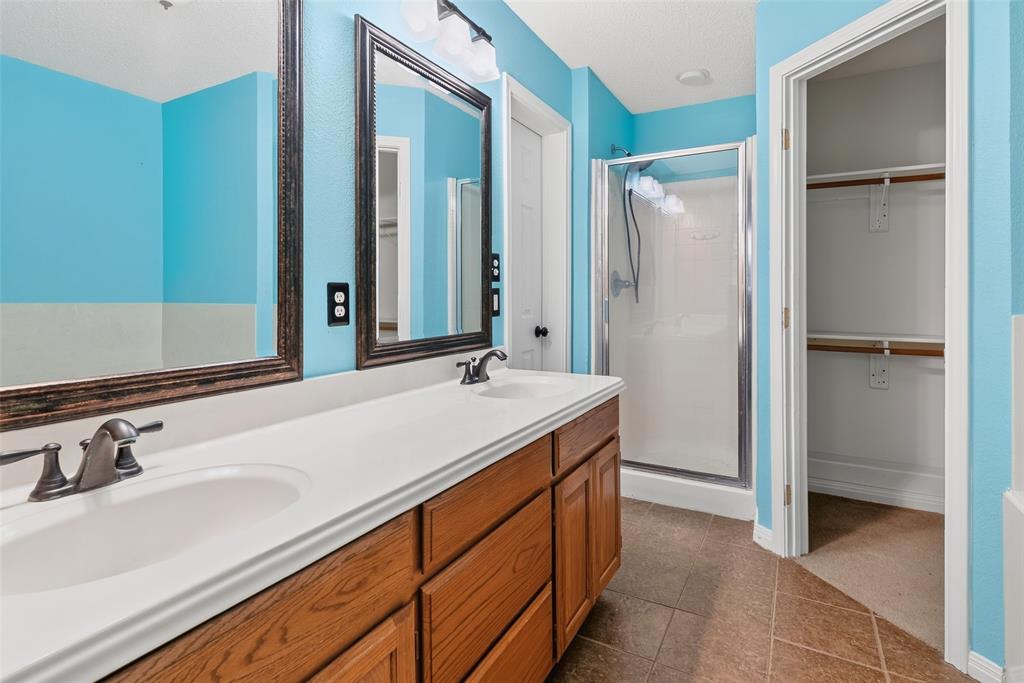 124 Topaz Circle Hewitt, TX 76643 - Photo 17 of 35 Bathroom featuring a dual vanity with a white countertop and wood-finish cabinetry