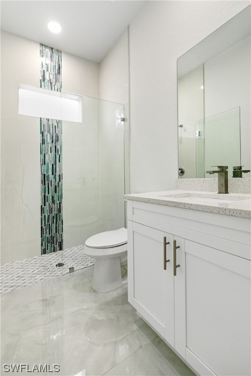 1119 Colonial Street East Lehigh Acres, FL 33974 - Photo 11 of 17 a bathroom with a sink a toilet and a mirror