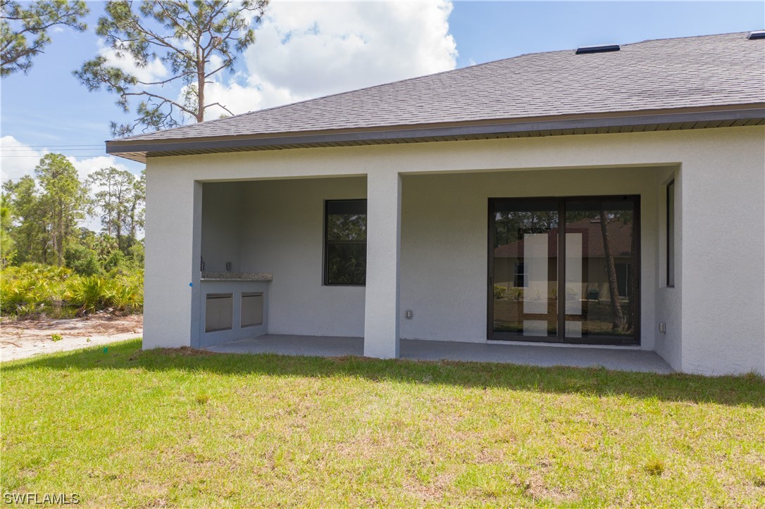 1119 Colonial Street East Lehigh Acres, FL 33974 - Photo 15 of 17 a view of a house with a yard