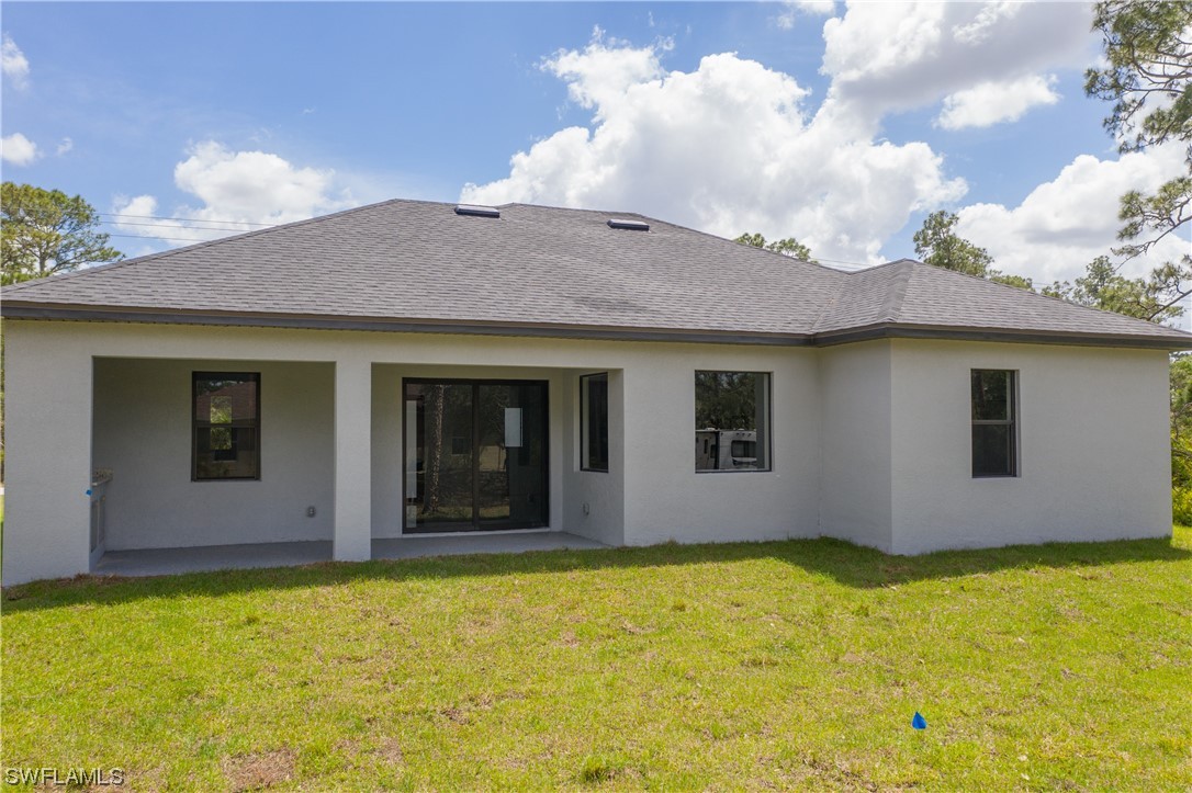1119 Colonial Street East Lehigh Acres, FL 33974 - Photo 16 of 17 a view of house with yard