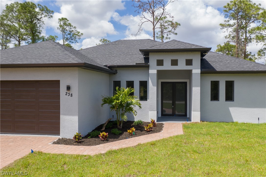 1119 Colonial Street East Lehigh Acres, FL 33974 - Photo 2 of 17 a view of a house with sitting area and yard