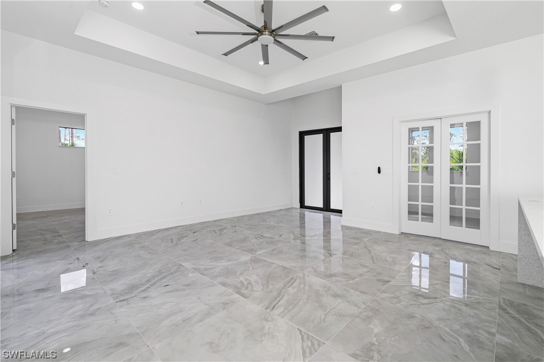 1119 Colonial Street East Lehigh Acres, FL 33974 - Photo 6 of 17 an empty room with windows and entrance to other room