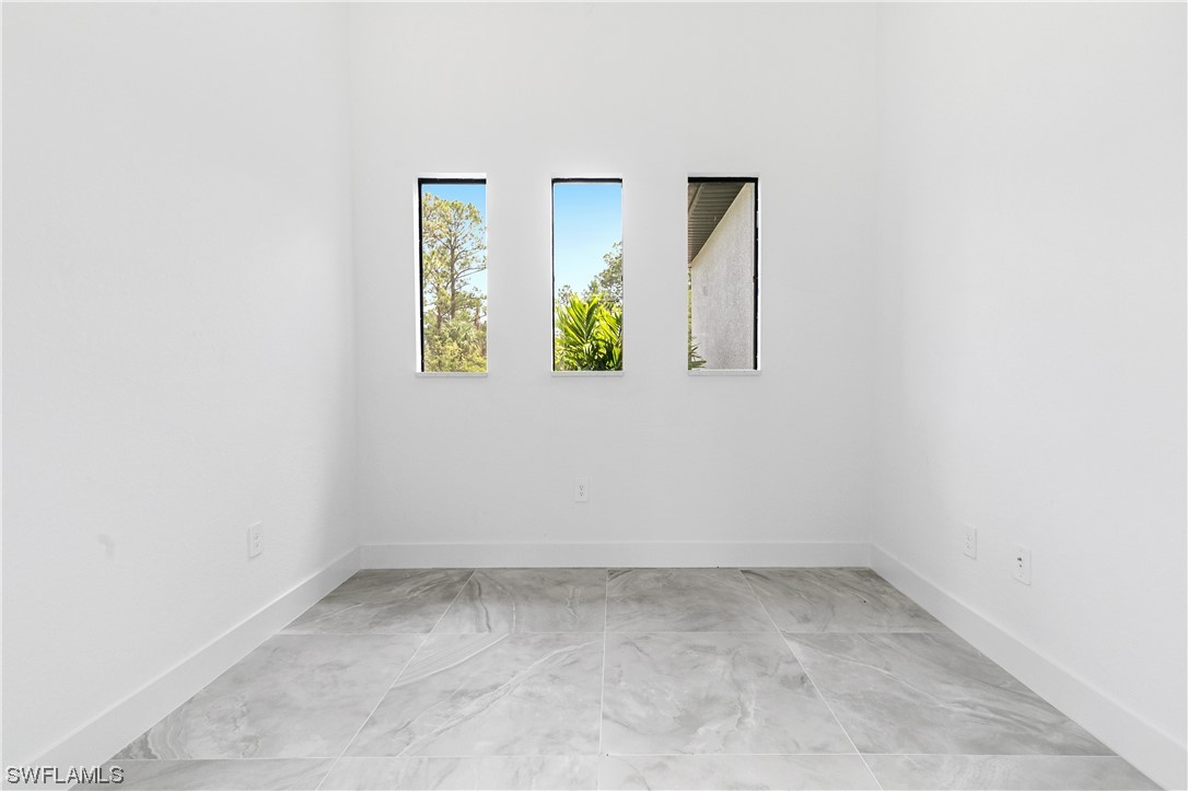 1119 Colonial Street East Lehigh Acres, FL 33974 - Photo 7 of 17 an empty room with windows