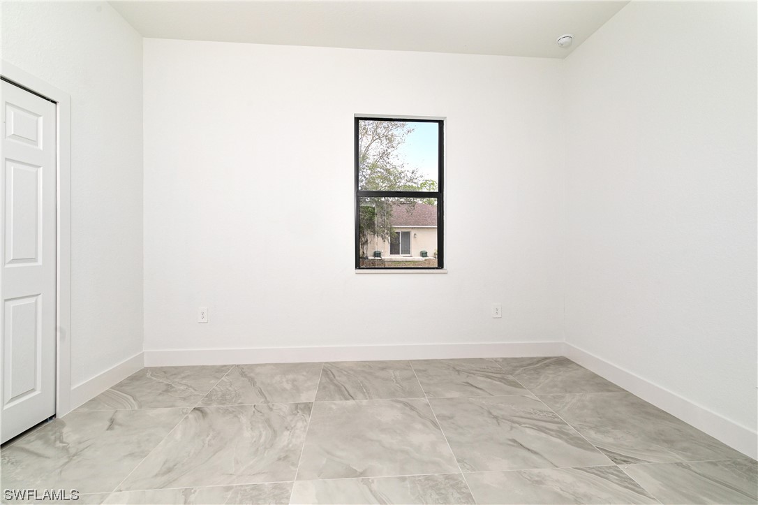 1119 Colonial Street East Lehigh Acres, FL 33974 - Photo 8 of 17 an empty room with a window