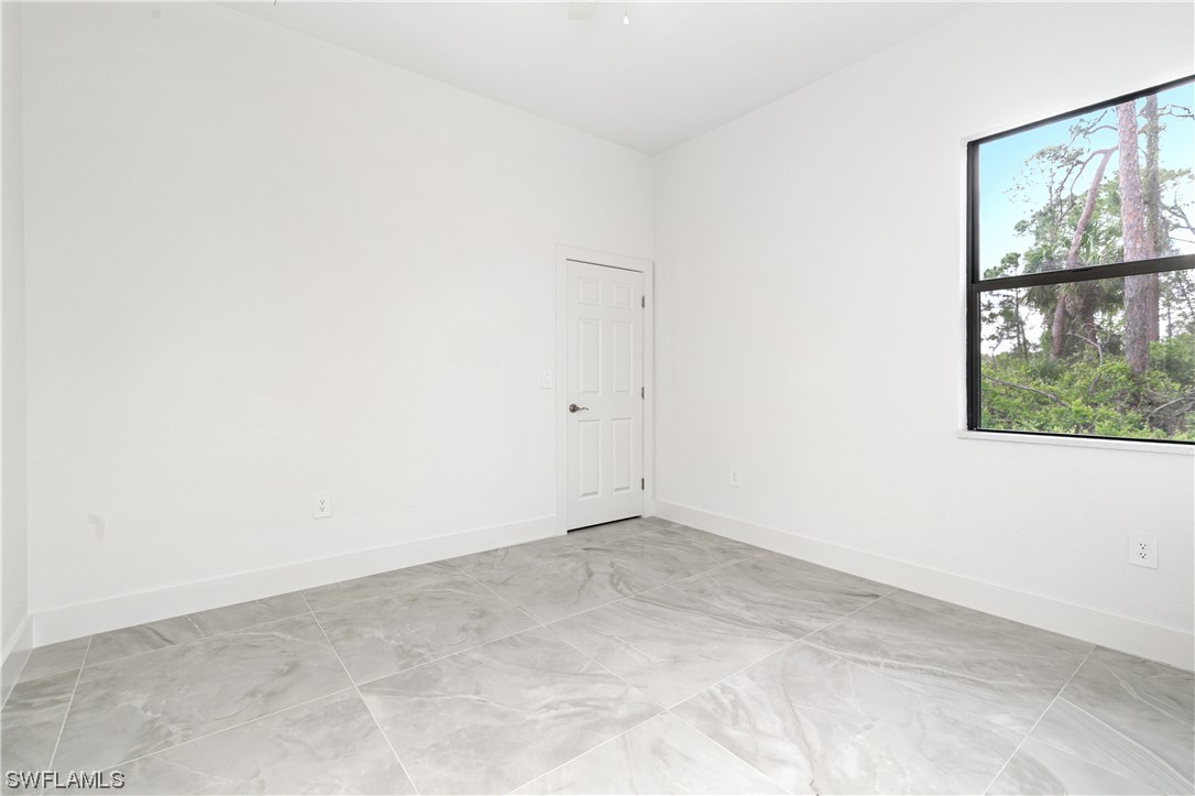 1119 Colonial Street East Lehigh Acres, FL 33974 - Photo 9 of 17 an empty room with a window