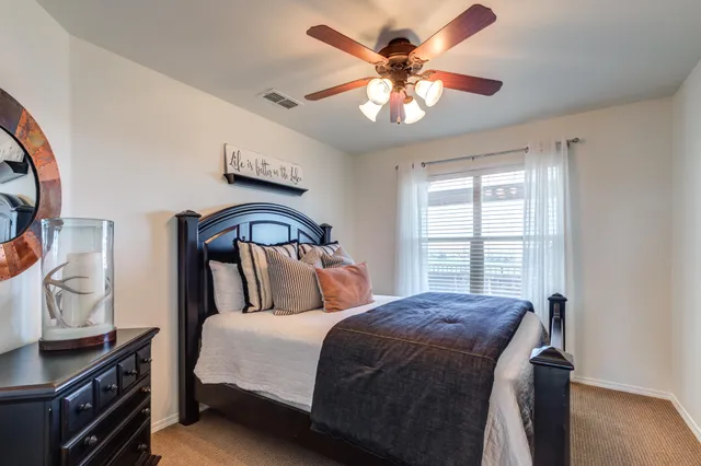 a bedroom with a large bed and a window
