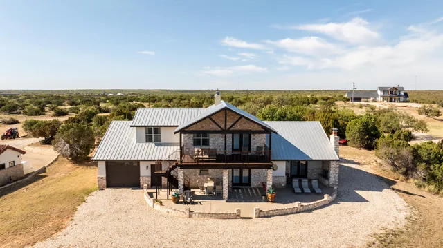 a living room with fireplace furniture and a flat screen tv