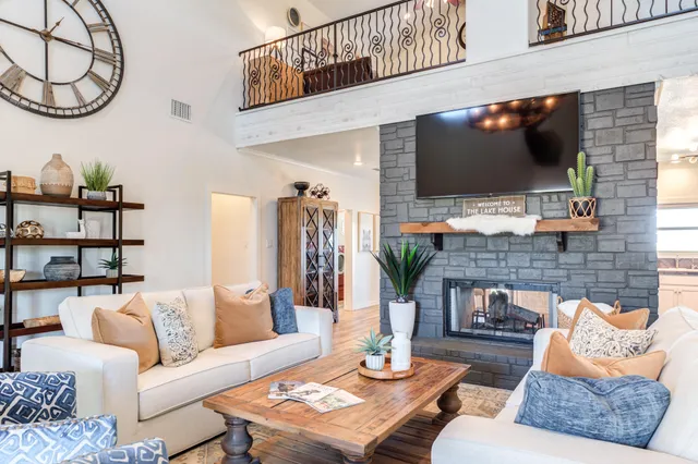a living room with fireplace furniture and a flat screen tv