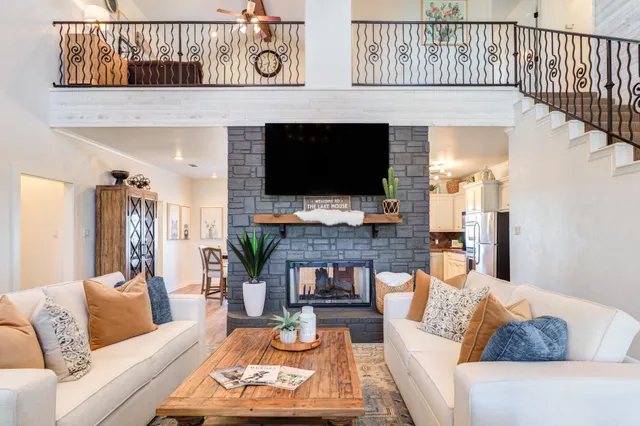a living room with furniture fireplace and a flat screen tv