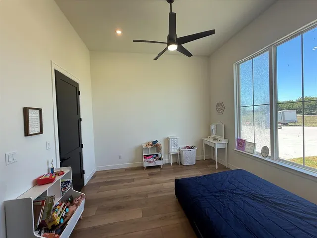 a bedroom with furniture and a window