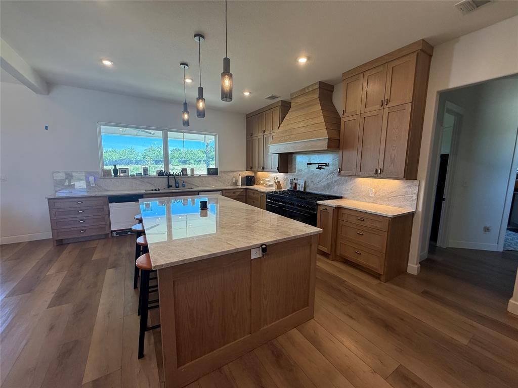 2798 Mockingbird Lane Moody, TX 76557 - Photo 20 of 35 a kitchen with a sink stove and wooden floor