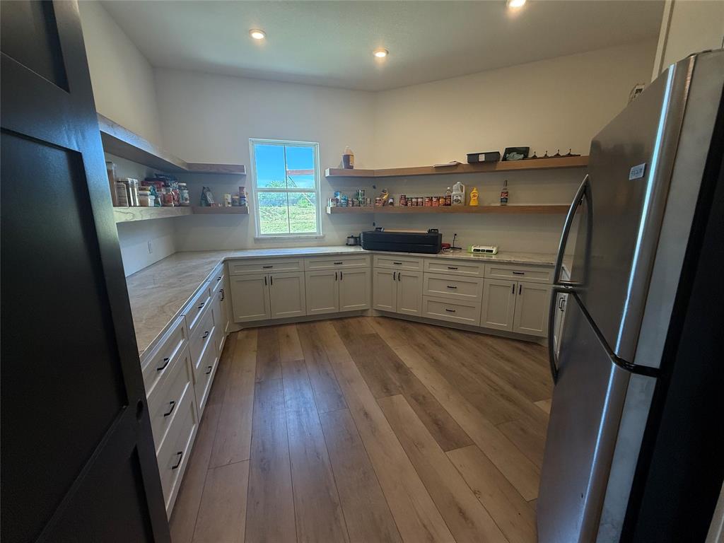 2798 Mockingbird Lane Moody, TX 76557 - Photo 22 of 35 a kitchen with cabinets a sink and wooden floor
