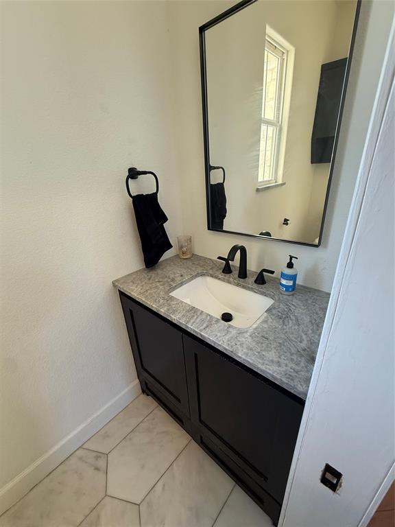 2798 Mockingbird Lane Moody, TX 76557 - Photo 25 of 35 a bathroom with a granite countertop sink and a mirror
