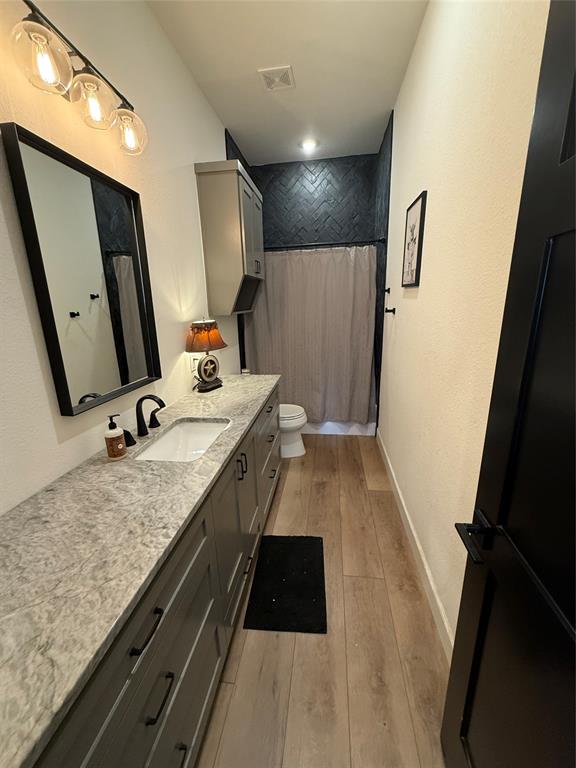 2798 Mockingbird Lane Moody, TX 76557 - Photo 31 of 35 a bathroom with a granite countertop sink a mirror and vanity