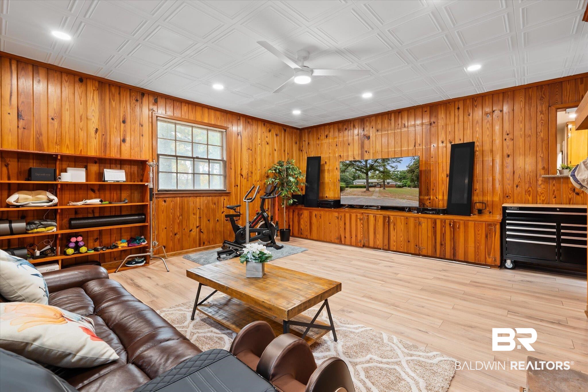 162 Bit And Spur Terrace Mobile, AL 36608 - Photo 9 of 29 Living room with ceiling fan, light hardwood / wood-style flooring, and wooden walls