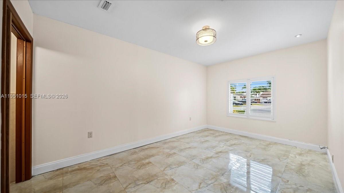 9798 Southwest 147th Place Miami, FL 33196 - Photo 13 of 17 a view of an empty room with a window
