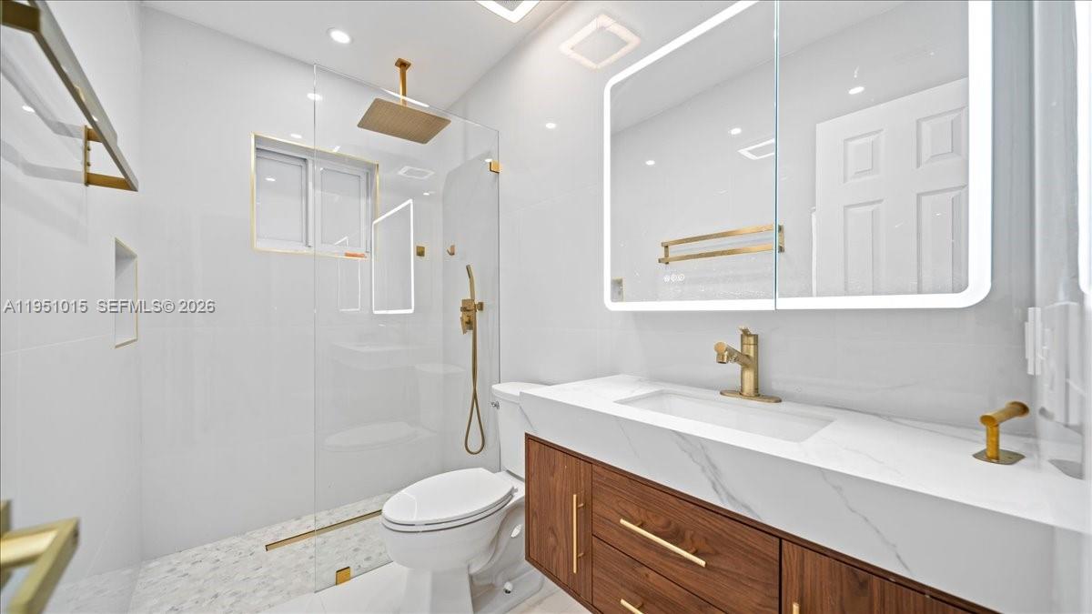 9798 Southwest 147th Place Miami, FL 33196 - Photo 8 of 17 a bathroom with a sink a toilet and shower