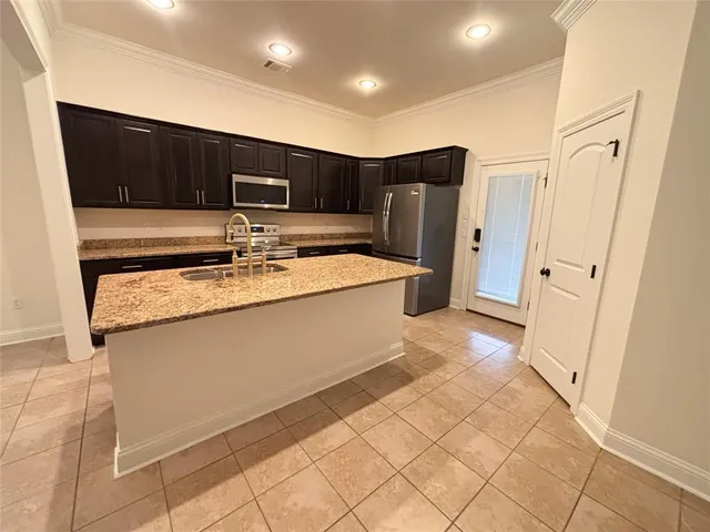a kitchen with stainless steel appliances a refrigerator and a stove