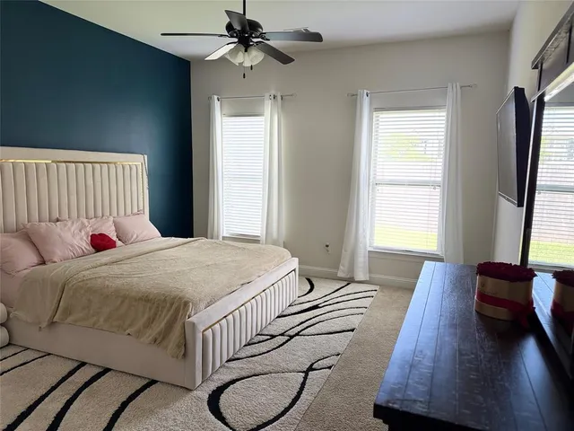 a bedroom with a bed and a window