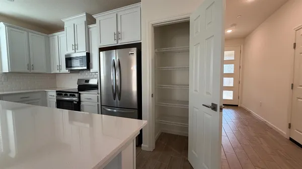 a kitchen with stainless steel appliances granite countertop a refrigerator and a sink