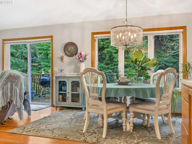a dining room with furniture a chandelier and wooden floor