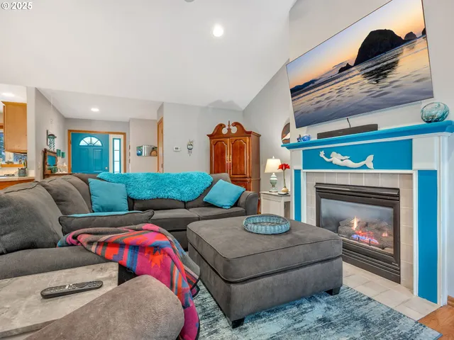 a living room with furniture a fireplace and a window