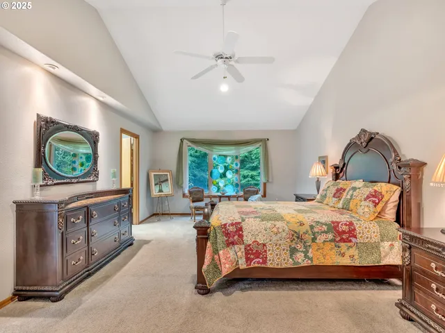 a bedroom with a bed and a flat tv screen on dresser