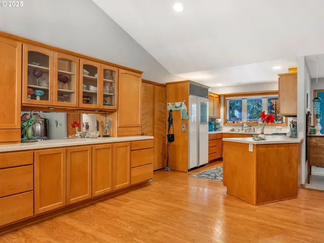 a kitchen with stainless steel appliances granite countertop a refrigerator and a sink