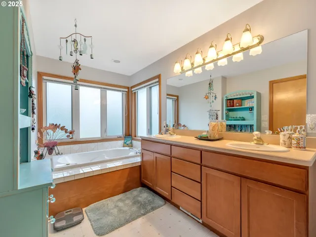 a spacious bathroom with a large tub and sink