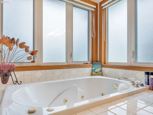 a bathroom with a bathtub and a window