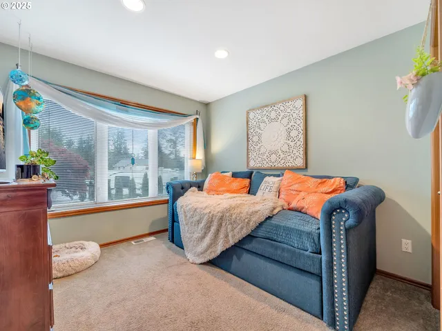 a bed sitting in a room next to a window