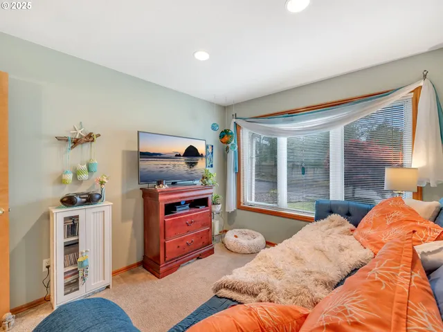 a bedroom with furniture and a flat screen tv
