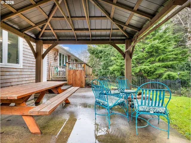 a porch area with chairs and wooden floor