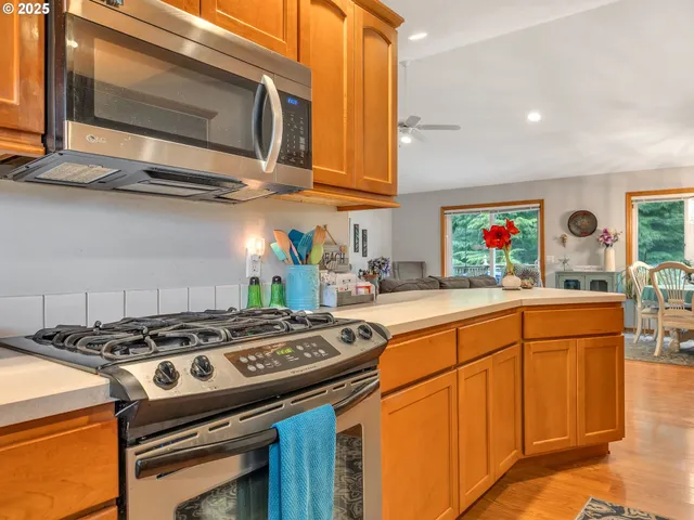 a kitchen with stainless steel appliances granite countertop a stove and a microwave