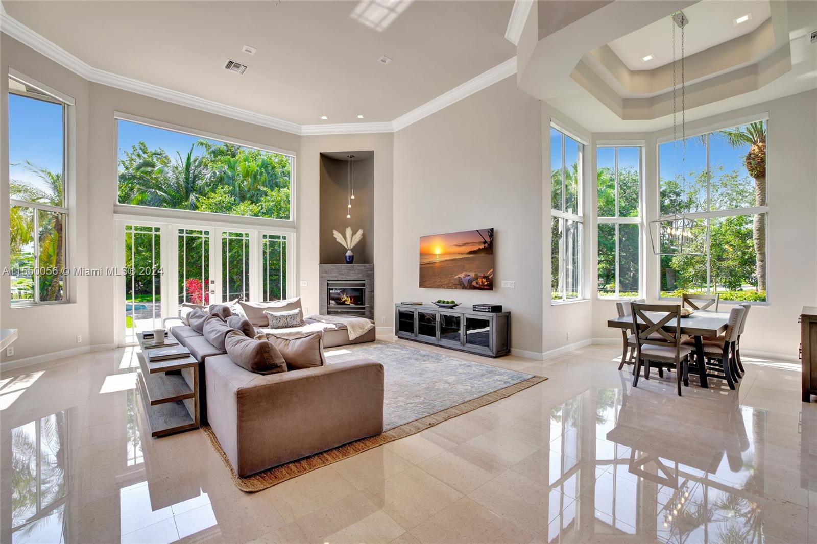 2725 Windmill Ranch Road Weston, FL 33331 - Photo 20 of 99 a living room with furniture a flat screen tv and a large window