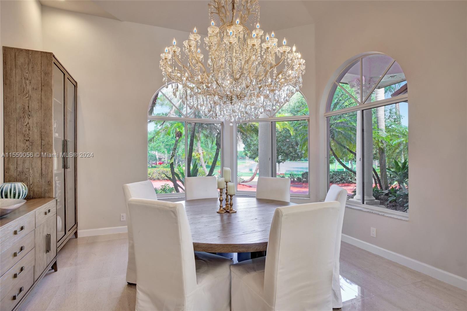 2725 Windmill Ranch Road Weston, FL 33331 - Photo 30 of 99 a view of a dining room with furniture a chandelier and large windows