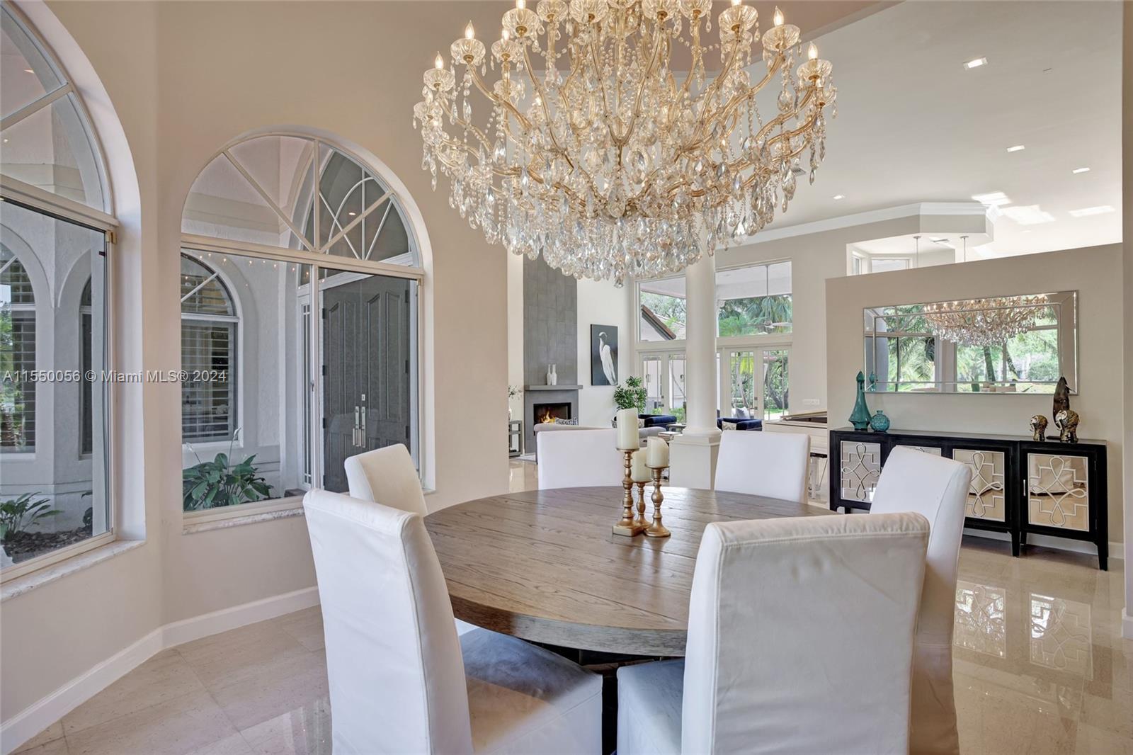 2725 Windmill Ranch Road Weston, FL 33331 - Photo 31 of 99 a view of a dining room with furniture a chandelier and wooden floor