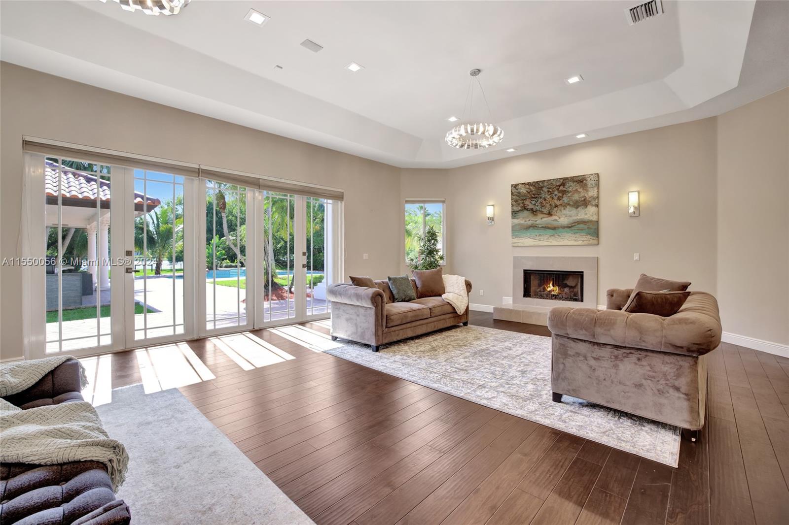 2725 Windmill Ranch Road Weston, FL 33331 - Photo 38 of 99 a living room with furniture fireplace and a large window