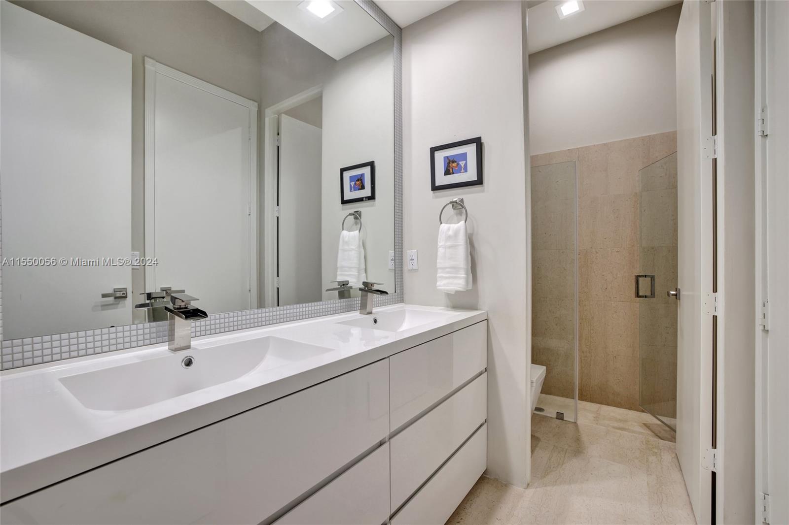 2725 Windmill Ranch Road Weston, FL 33331 - Photo 53 of 99 a bathroom with a double vanity sink and a mirror