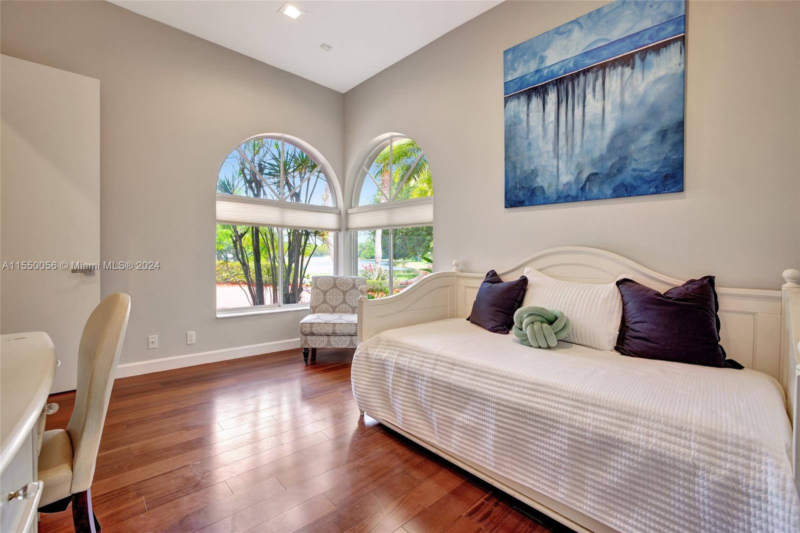 2725 Windmill Ranch Road Weston, FL 33331 - Photo 56 of 99 a bedroom with a bed and a painting on the wall