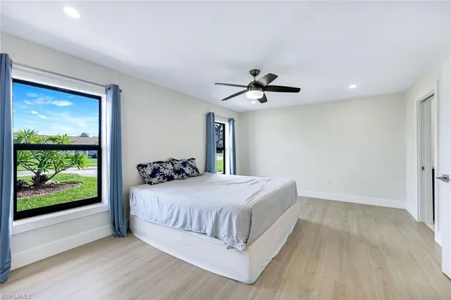 a bedroom with a large bed and a chandelier