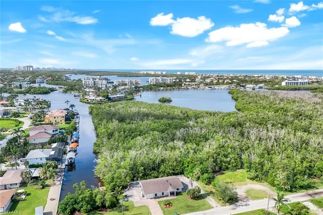 a front view of a house with a garden and plants
