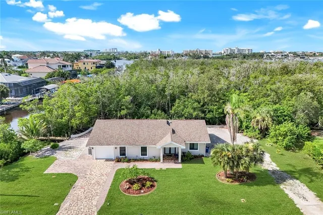 an aerial view of a house with garden space and outdoor seating