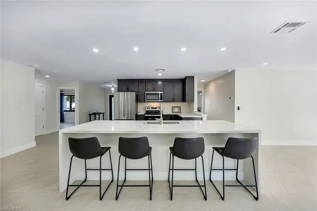 a kitchen with stainless steel appliances a sink stove and cabinets