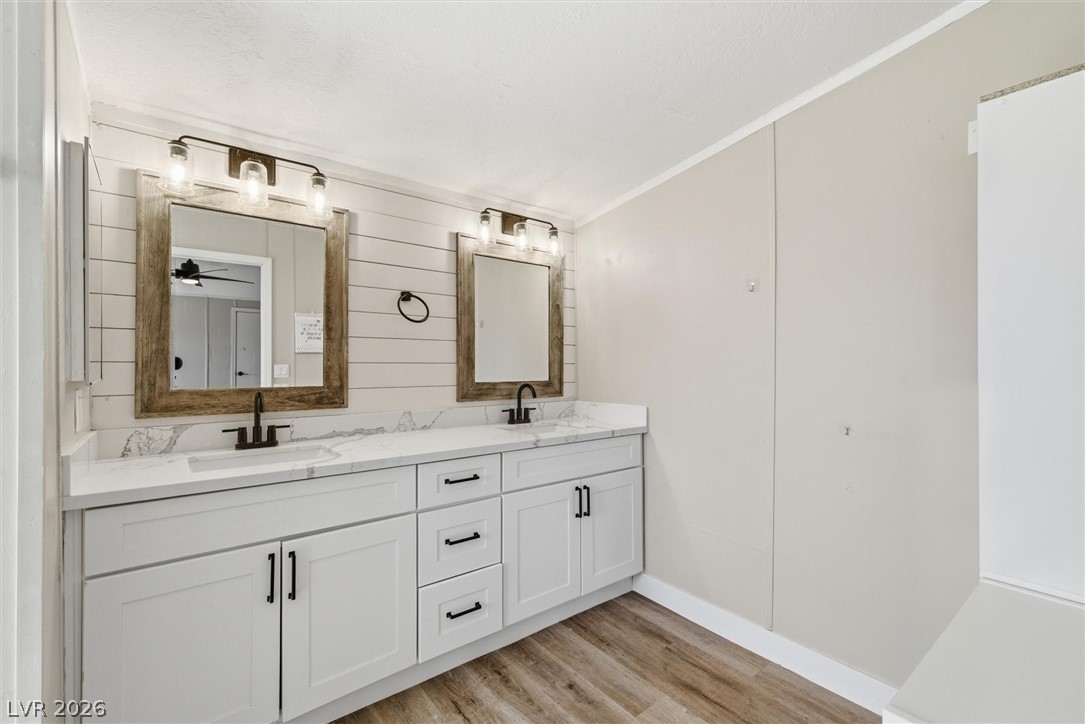 4331 Retread Road Pahrump, NV 89048 - Photo 15 of 31 A double vanity with marbled countertops and rustic wood-framed mirrors anchors this well-appointed bathroom.