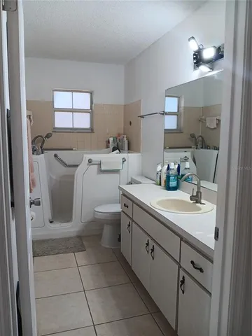 a kitchen with a stove a sink and a refrigerator
