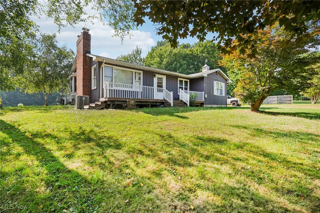 2916 Sexton Road Geneva, OH 44041 - Photo 3 of 23 Ranch-style home featuring a chimney, a front lawn, and a wooden deck