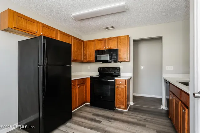 a kitchen with stainless steel appliances granite countertop a refrigerator stove and sink