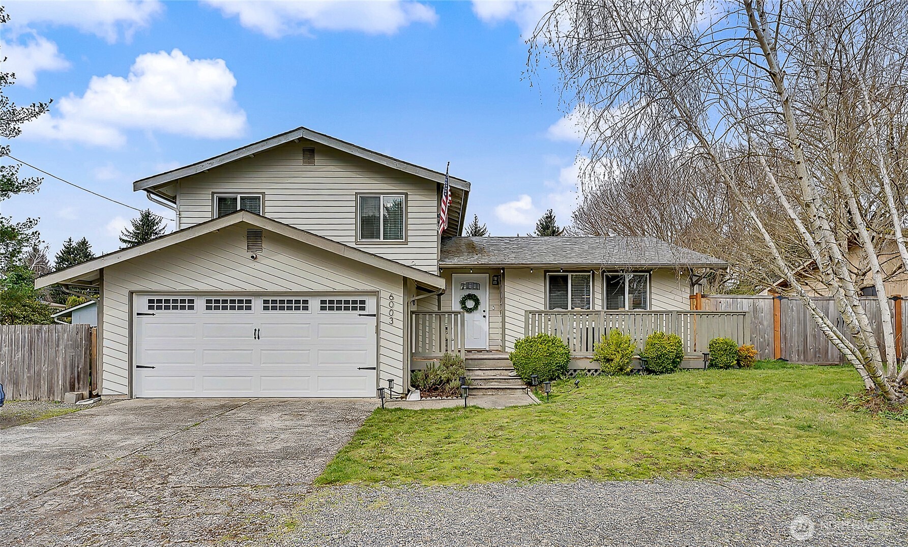 a front view of a house with a garden and plants