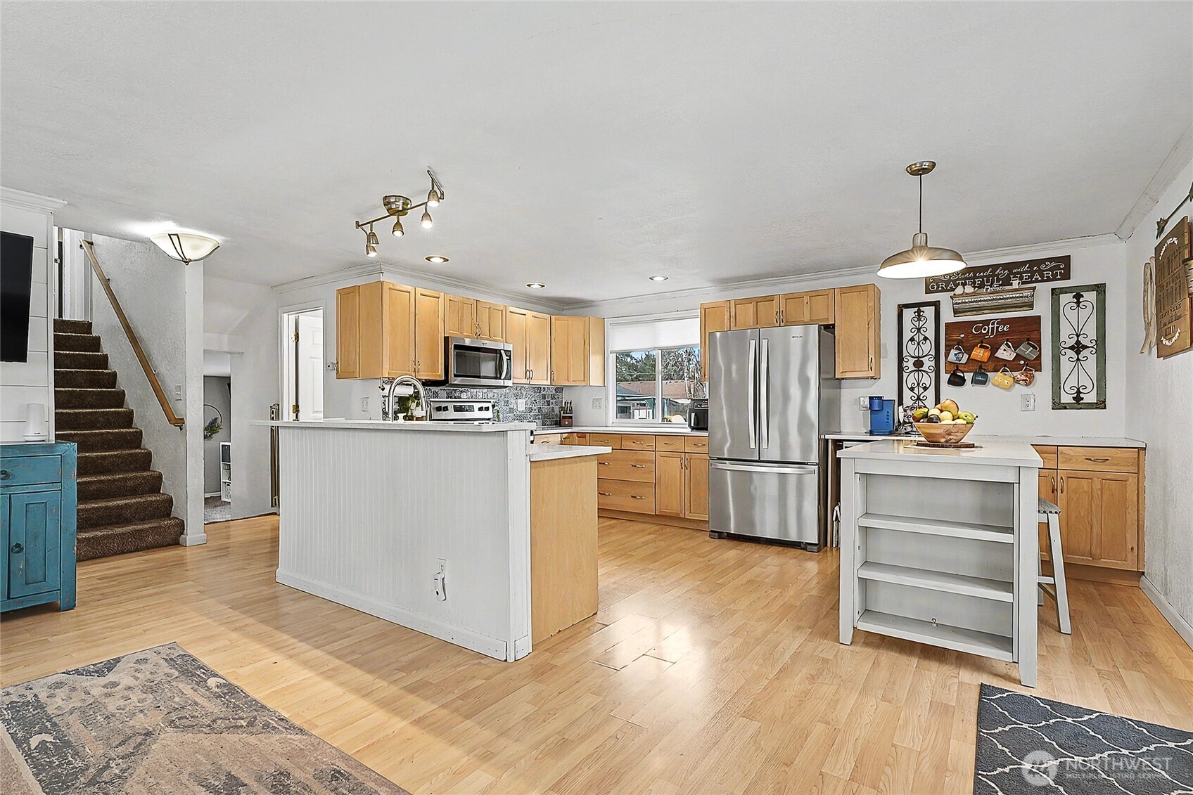 6003 Armour Loop Southeast Olympia, WA 98513 - Photo 7 of 25 a kitchen with kitchen island white cabinets and stainless steel appliances